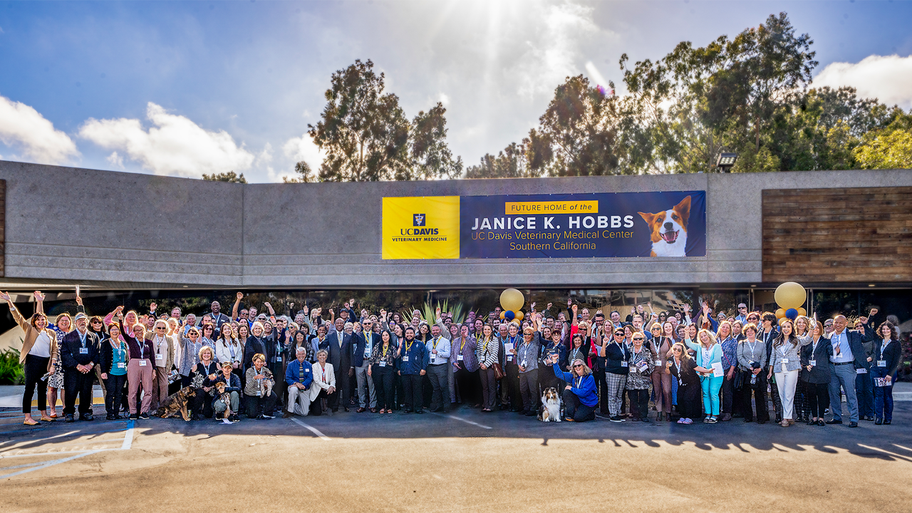 A group of people standing in front of the building